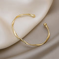 A Sleek And Stylish Twisted Texture Golden Bangle